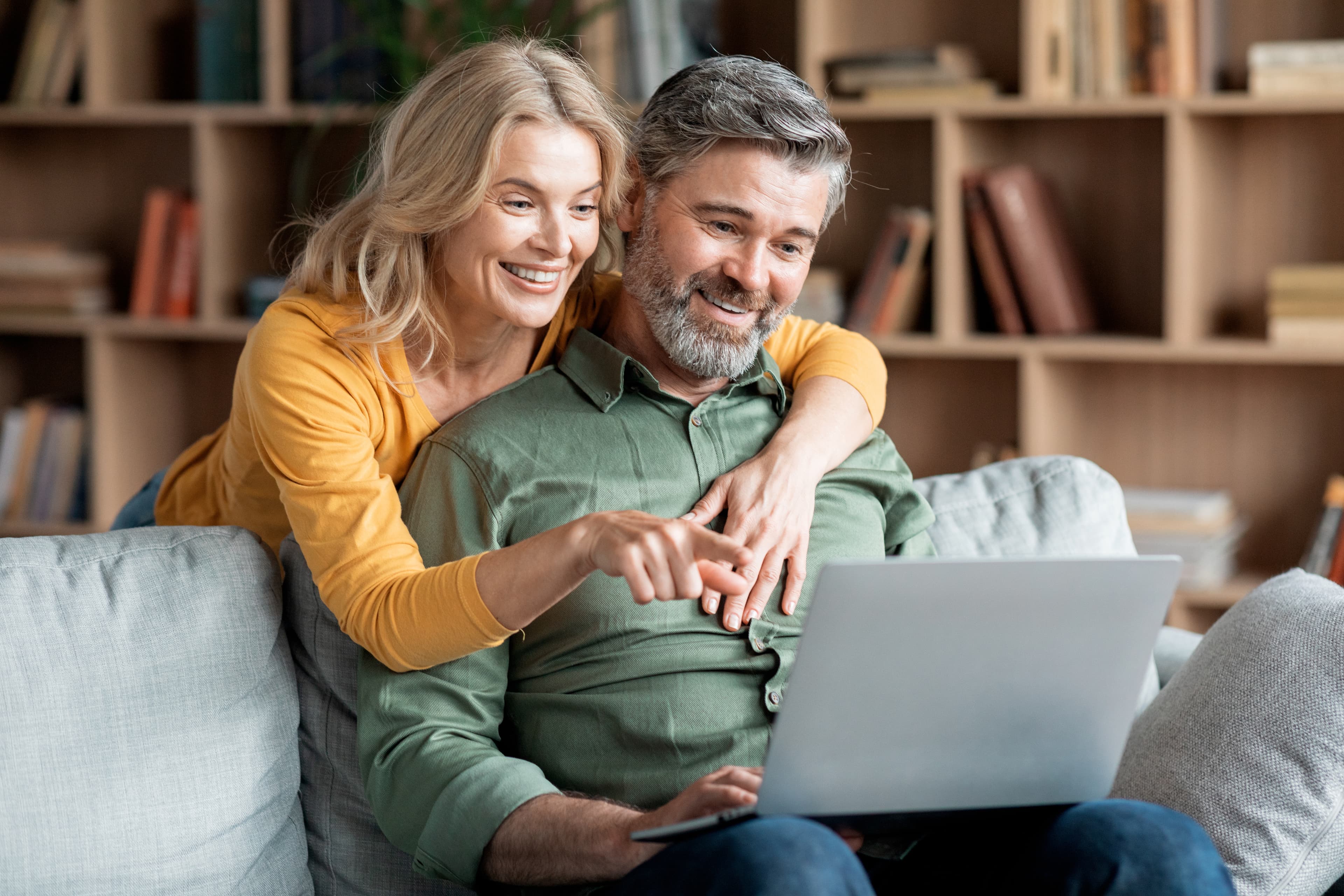Couple reviewing their retirement number together on a laptop.